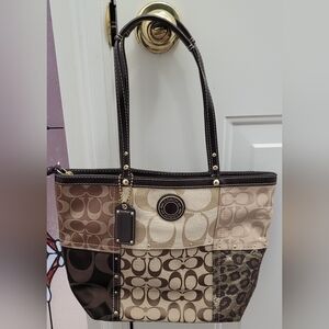 Never been used. Coach bag with zipper closure.  Approx 13" Across, 16" H.